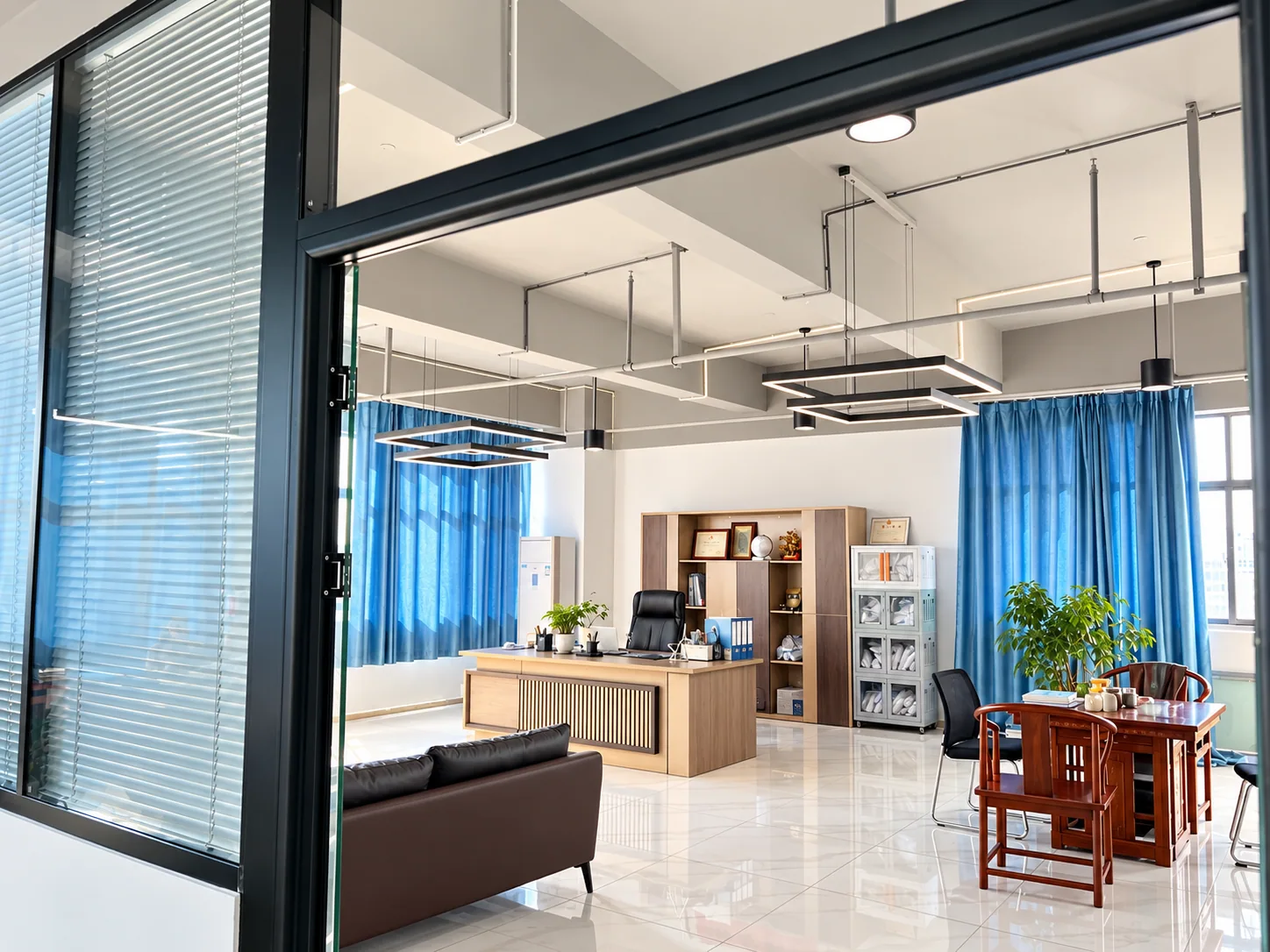 Office and meeting area with a desk, sample cabinet and seating